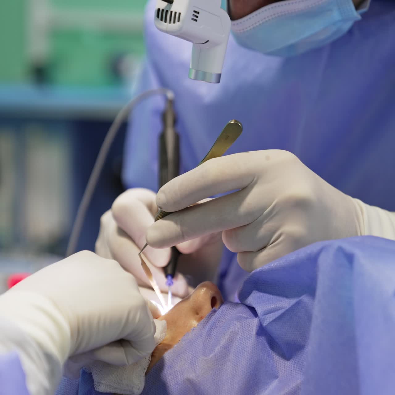 Blepharoplasty performed with the usage of modern devices and tools. Unrecognized surgeon wearing headlight carries out the procedure. Close up