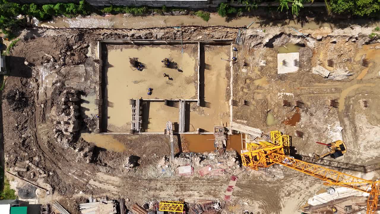 Aerial View of Workers and Crane at a Construction Site Foundation