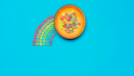 Colorful-cereals-with-milk,-stop-motion-animation.-Rainbow-cereals-breakfast,-top-view