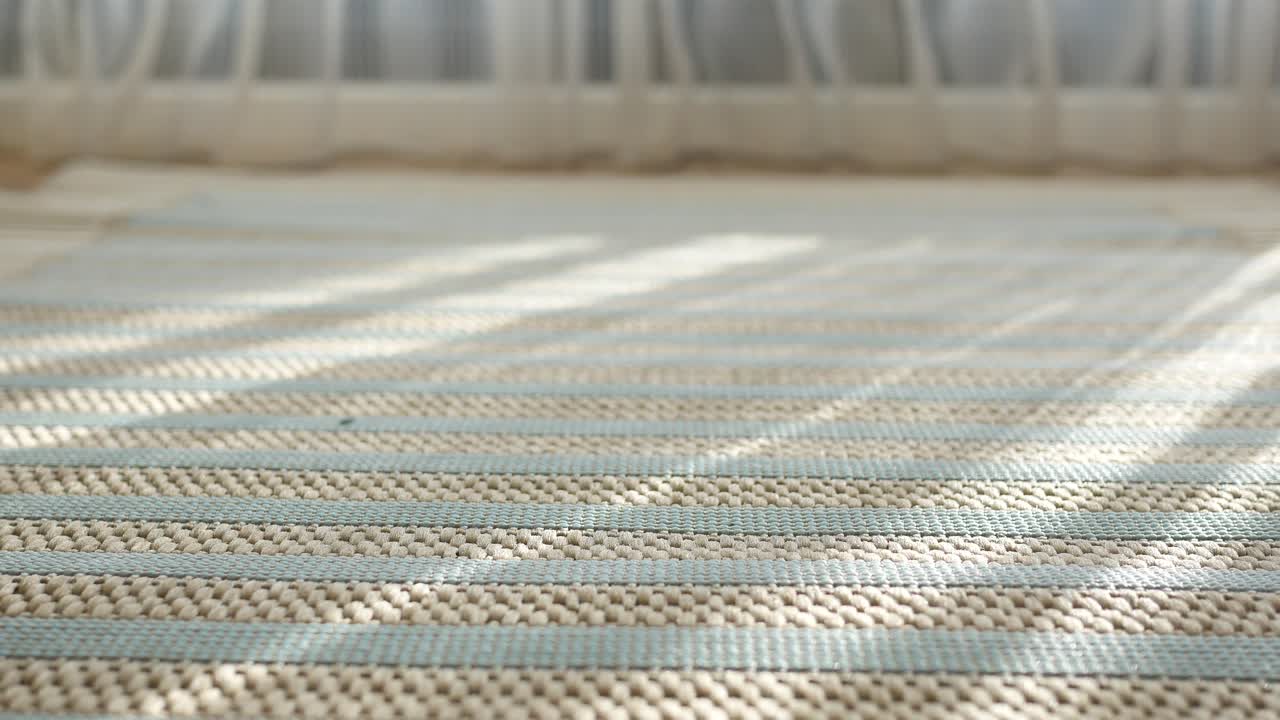Striped Beige and Light Green Rug with Sunlight Shadows