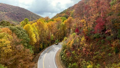 aerial-pullout-fall-foliage-with-car-and-motorcycle-along-roadway-in-the-mountains-of-northern-georgia