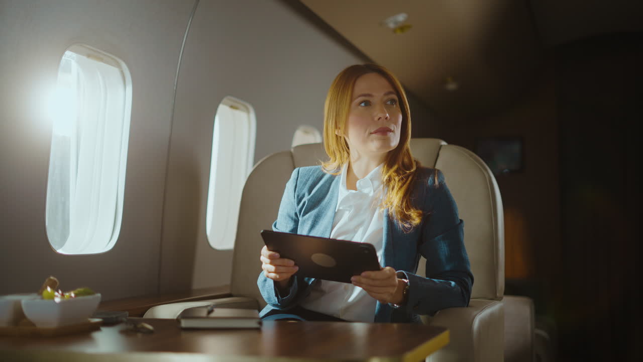 Businesswoman Using Tablet on Private Jet