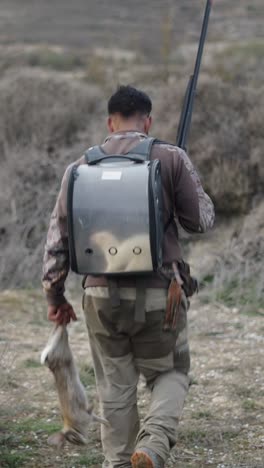 hunter with rabbit and shotgun