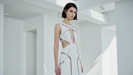 A Stunning White Fashion Dress Showcasing Elegant Cutouts and Contemporary Design in a Minimalist Setting, Perfect for Modern Fashion Enthusiasts