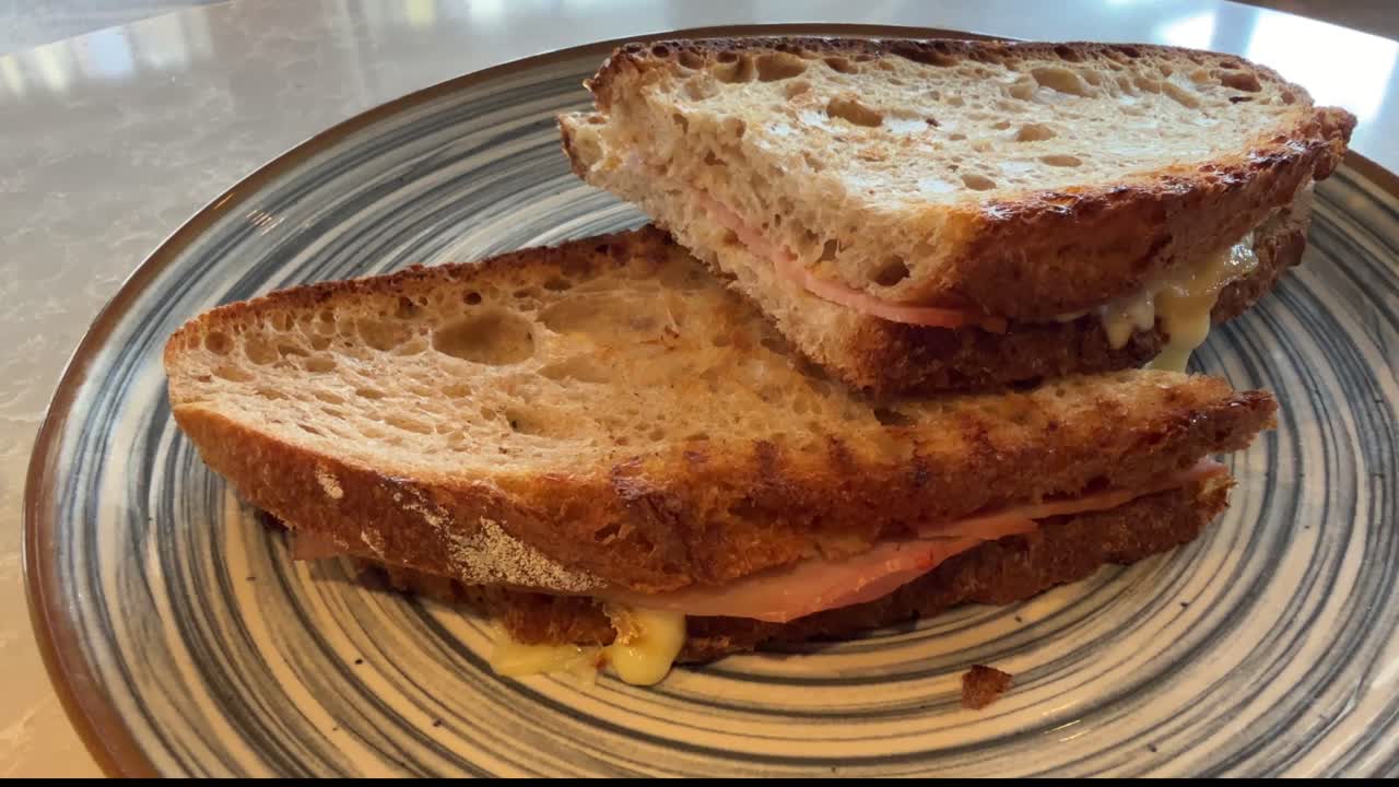 Close up of eating a warm grilled cheese sandwich