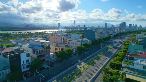 Drone-Flying-Over-Urban-Vietnamese-Houses,-Buildings,-Main-Road-Avenue