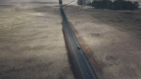 High-aerial-view-of-car-driving-along-road-in-Hawaii-Island