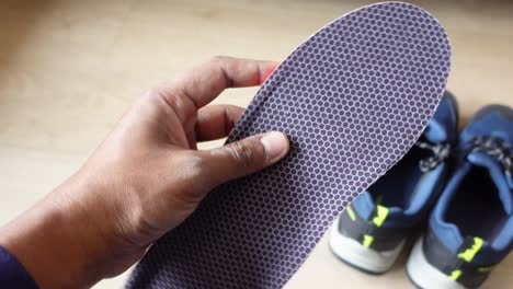 close-up of a pair of blue sneakers with insoles