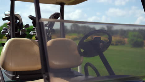 golf cart equipment clubs at green course. driving car stop at country club.