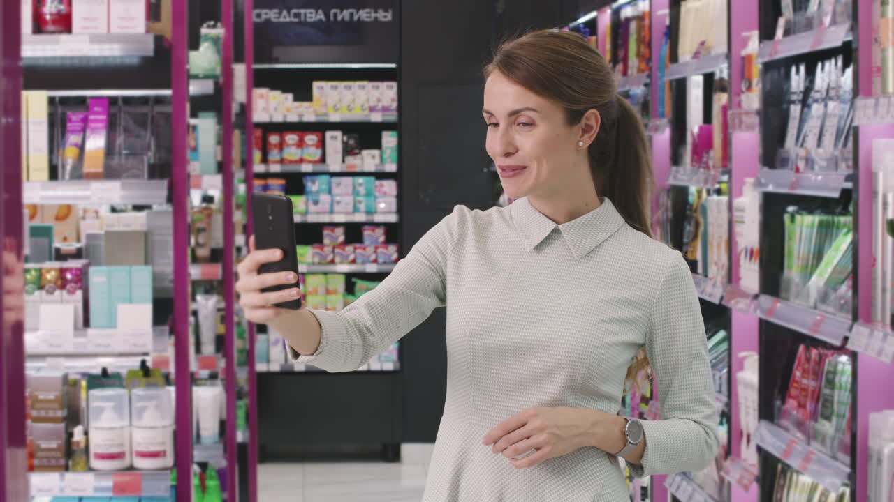Pretty Woman Having Video Chat In Cosmetics Store