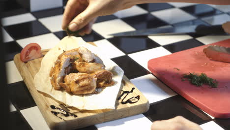 Chef taking steak off the grill, making presentation of dish