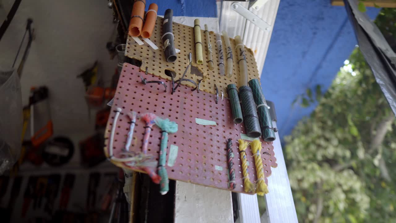 Colorful electrical cables arranged neatly on a workshop pegboard