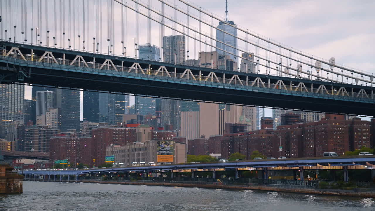 New York, USA, 1 August 2025: Evening lights of Manhattan Bridge and city skyline. The Manhattan Bridge with glowing city lights creates a scenic view in the evening