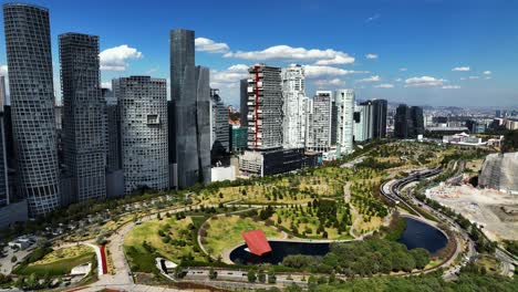 Aerial-view-over-the-Parque-La-Mexicana-park-towards-luxury-condos-in-Santa-Fe,-Mexico-city