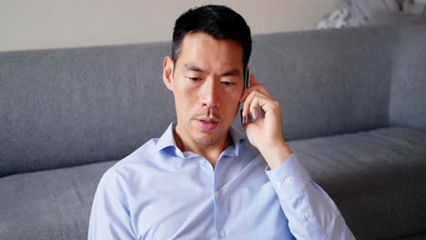 man talking on mobile phone in living room