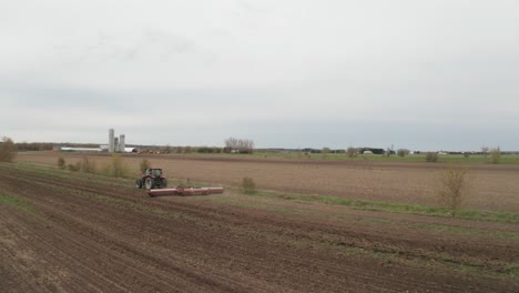 Granjero-Que-Trabaja-En-El-Campo-Conduciendo-Maquinaria-De-Remolque-De-Tractores-Para-Arar,-Labrar,-Desmontar-Un-Campo-Para-Plantar