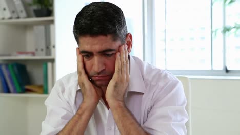 Businessman-having-a-headache-at-his-desk