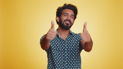 indian young man raises thumbs up agrees or gives positive reply recommends advertisement likes good