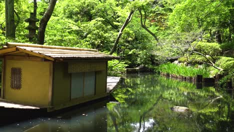 right pan of traditional japanese garden with lake and boat