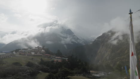 panning shot from a mountain revealing village of tengboche in the himalayas of nepal