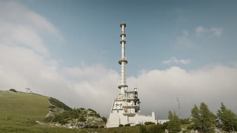 a shot of a radio tower on the top of mountain krvavec