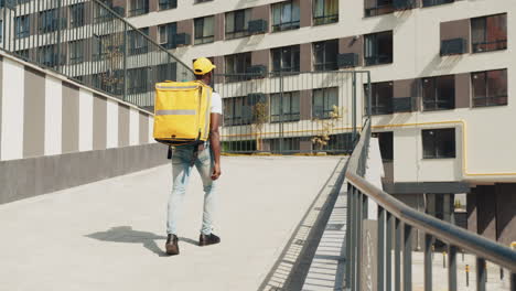 delivery person walking down urban stairs