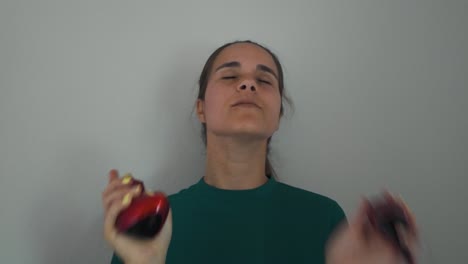 woman smiles while spraying perfume on her neck