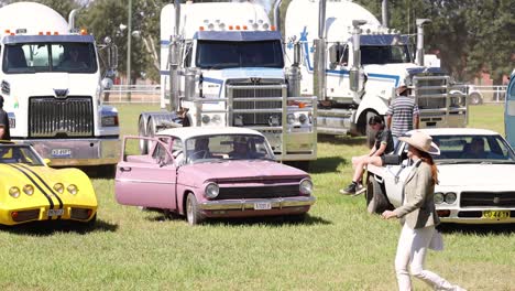 people interacting with classic cars and trucks