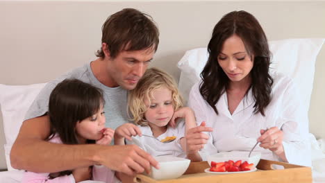 smiling family eating their breakfast