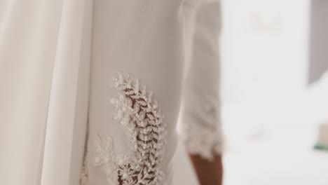 close up wedding dress arm sleeve details, bride preparing for ceremony