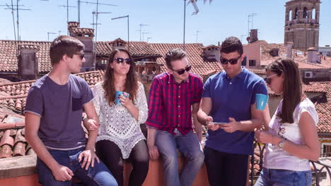 group of friends enjoying coffee on a rooftop in venice