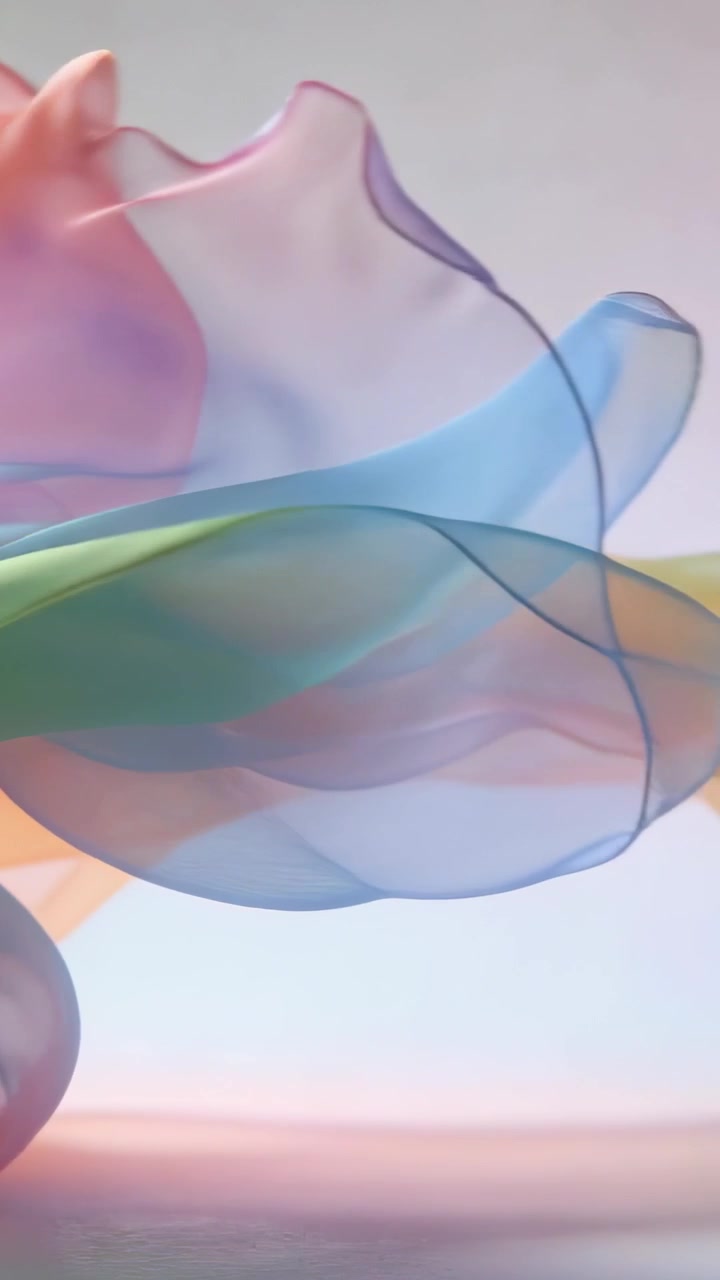 Vertical video: Swaying translucent silk ribbon from soft air flow at studio, mixing pastel hues