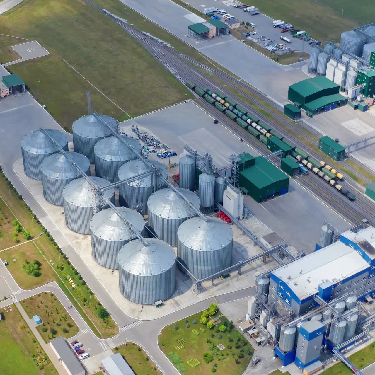 Big steel grain elevator warehouse. Modern agricultural architecture landscape