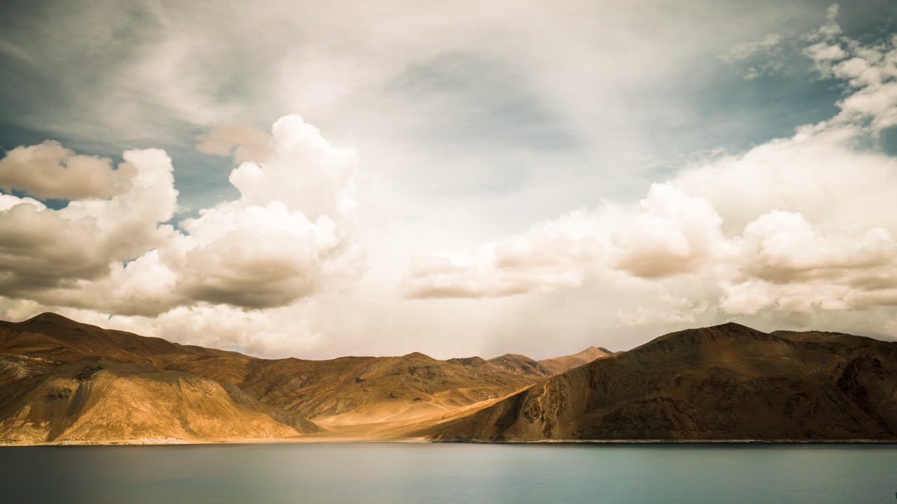 Pangong Tso high altitude salt water lake with swirling storm clouds, bordering India and China