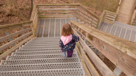 following a little girl walking down an outdoor staircase