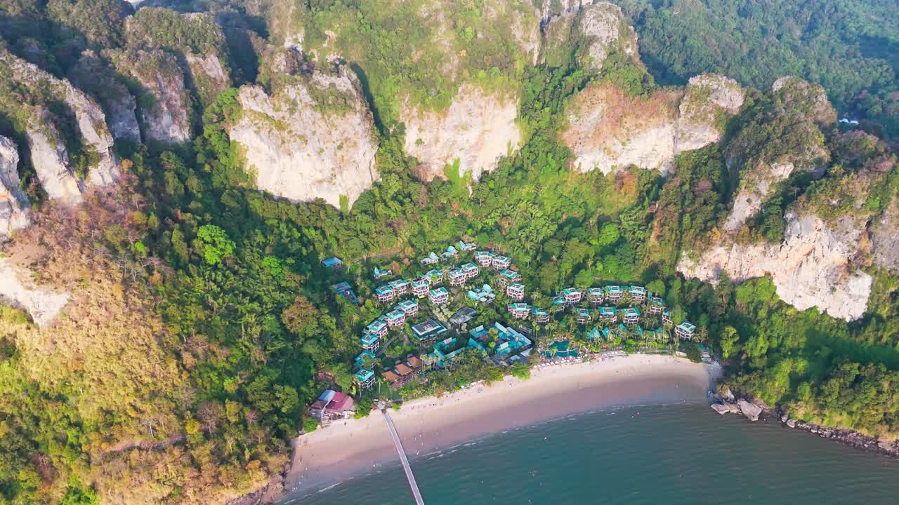 Aerial view of Ao Nang beach at sunset in Thailand, beach in Andaman sea, exotic Thai coastline in Krabi. Drone topdown pullback reveal shot.