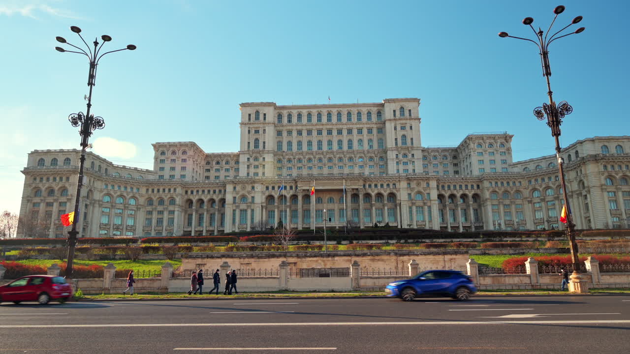 Cars passing in front of the Palace of the Parliament building in Bucharest, Romania