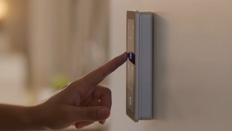 hand adjusting smart home thermostat