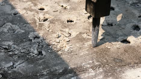 boring holes in old ground road by drilling rig machine. industrial concrete drilling at construction demolition work. site main road bangkok thailand.