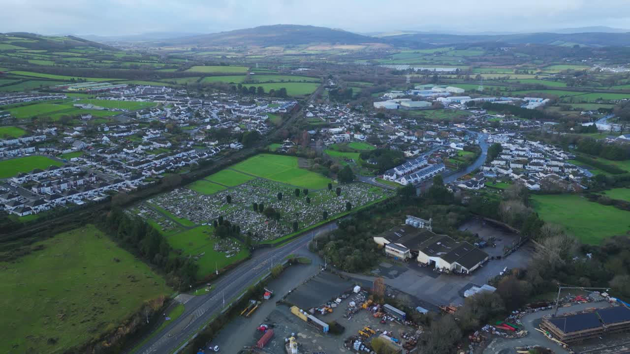 Aerial view of County Wicklow, Wicklow Town and Wicklow mountains in the background. An old cemetery next to a motorway in Ireland