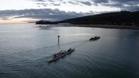 Aerial-close-up-shot-of-a-team-of-outrigger-canoes-rowing-across-the-ocean-in-O'ahu,-Hawaii