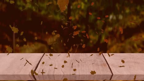 animación digital de múltiples hojas de otoño flotando sobre la superficie de madera contra el bosque