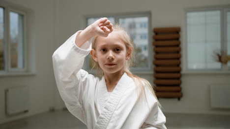 girl in white kimono in martial arts class