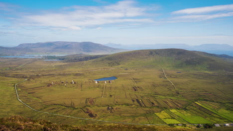 timelapse of remote village bogland and lake hillside landscape with clouds casting shadows in daylight viewed from minaugn heights in achill island in county mayo in ireland