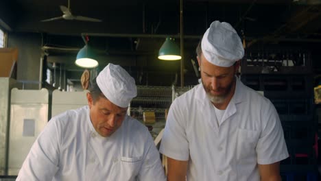 Chefs-kneading-pizza-dough-on-the-floured-table-4k