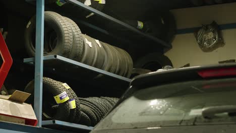 close-up of a garage with stacked tires and car