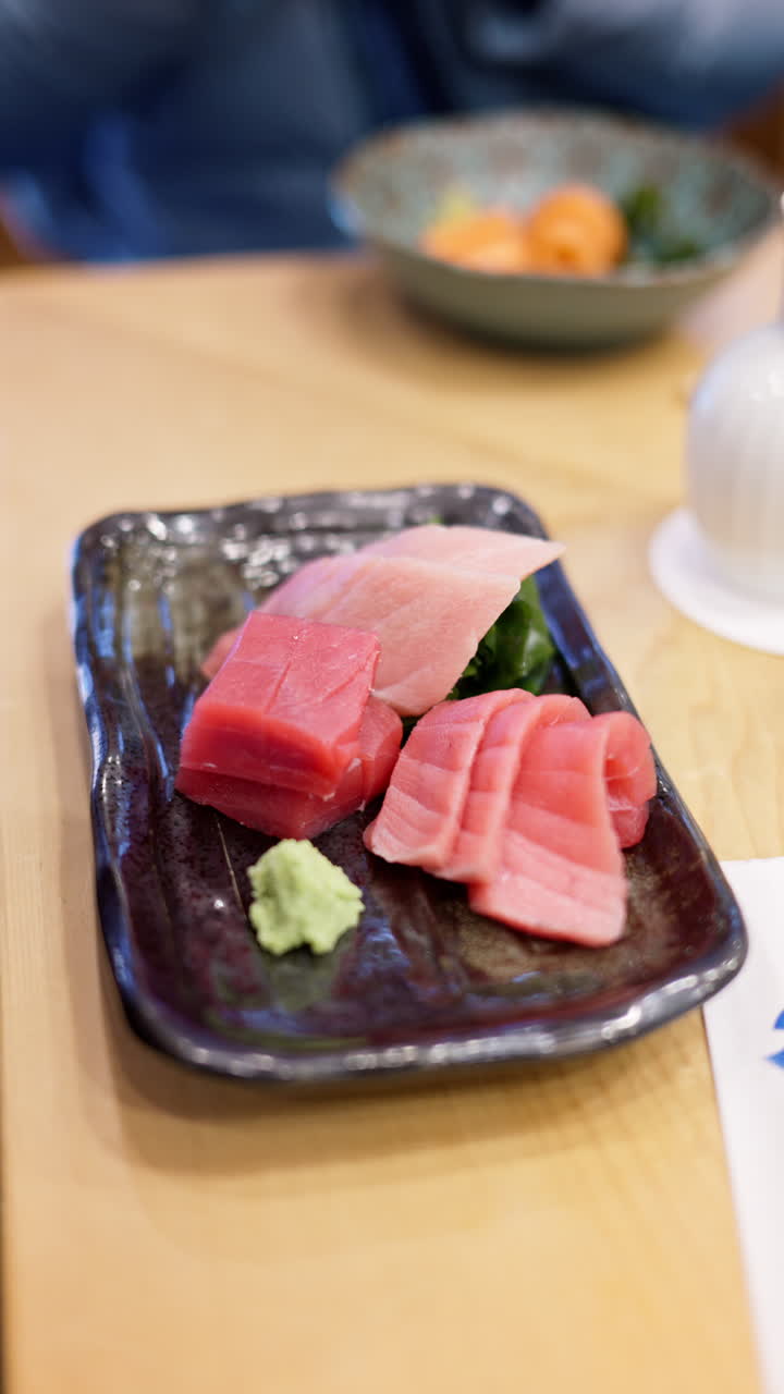 Close up of multiple pieces of tuna on display at the Tsukiji Fish Market in Japan. Vertical