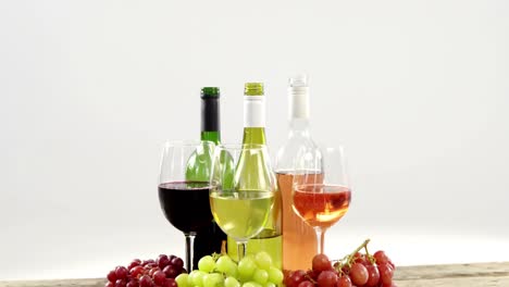 Grapes-and-wines-on-wooden-plank