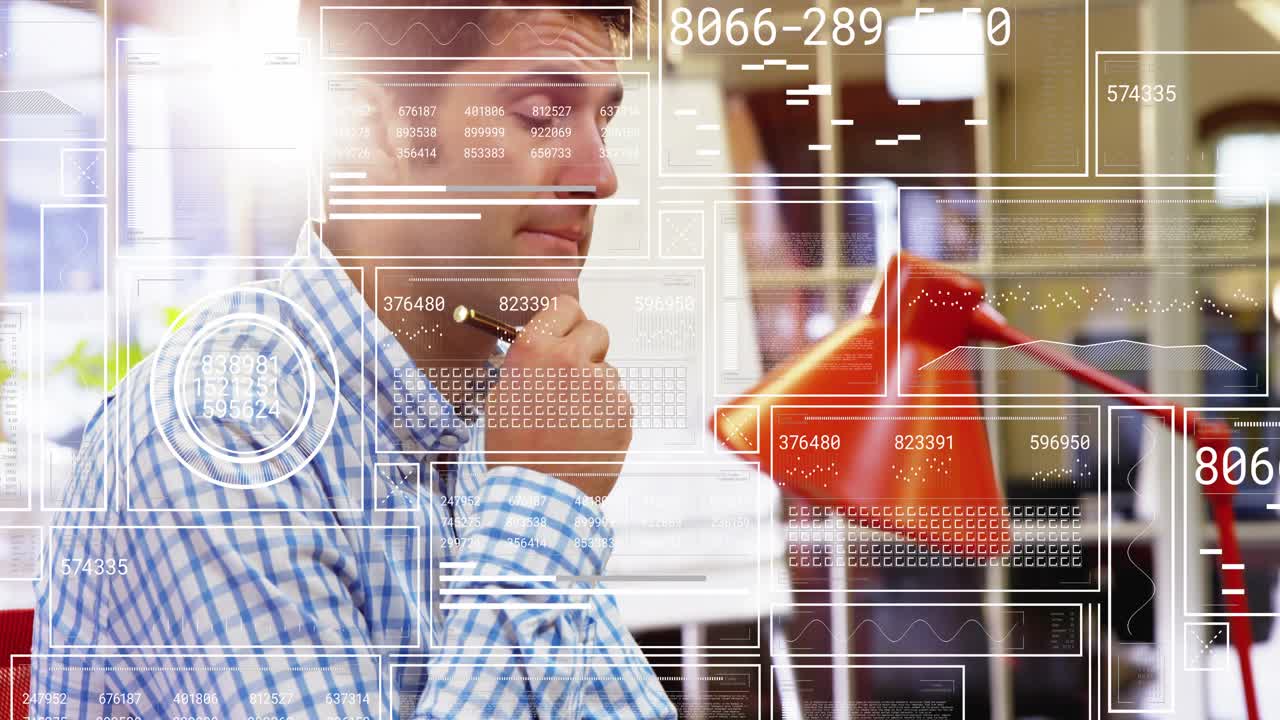 Mid adult man leaning forward and writing planning notes in office, glancing at coffee mug