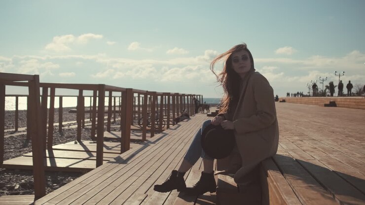 Woman Relaxing on a Beach Boardwalk
